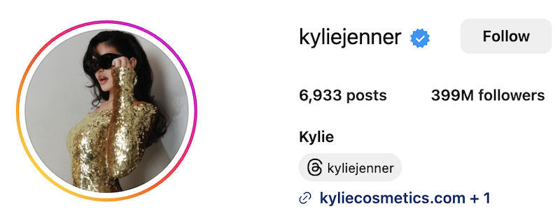  Instagram page of Kylie Jenner showing 399 million followers. She’s wearing a sparkly gold dress and black sunglasses that make her look like a very attractive bug.