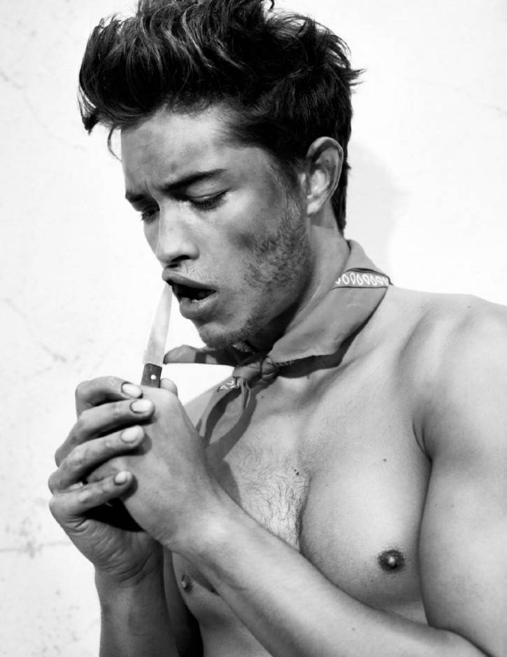 francisco lachowski covered in dirt with a knife on his lips wearing a kerchief shirtless in black and white editorial fashion photoshoot