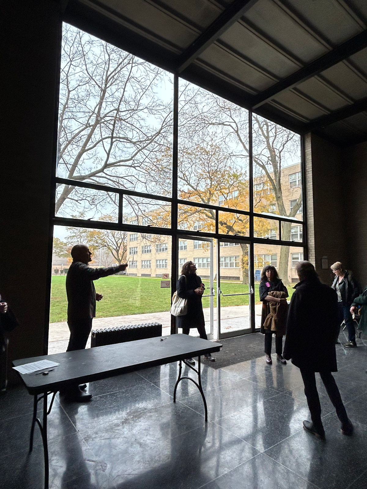 Silhouettes of visitors in front of the large front window of Carr Chapel, Mies's only religious building.