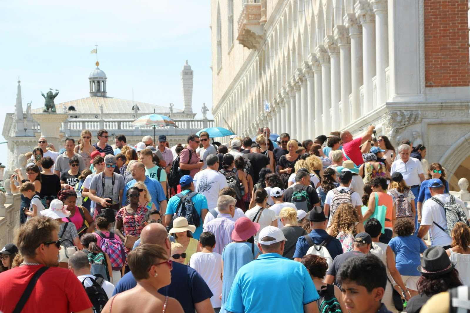 Considering the road not taken: A crush of tourists floods the streets and squares of Venice, Italy in the busy summer high season.