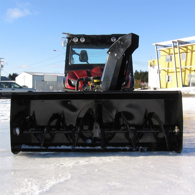 A front-facing image of a UTV with the Can-Am Defender 66" Vantage Snowblower by Bercomac installed. 