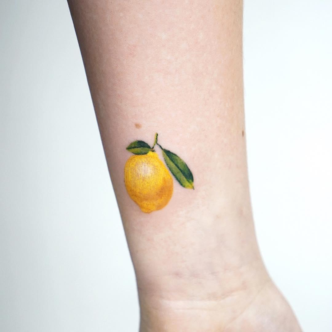 Tiny lemon tattoo by tattooist picsola - Tattoogrid.net