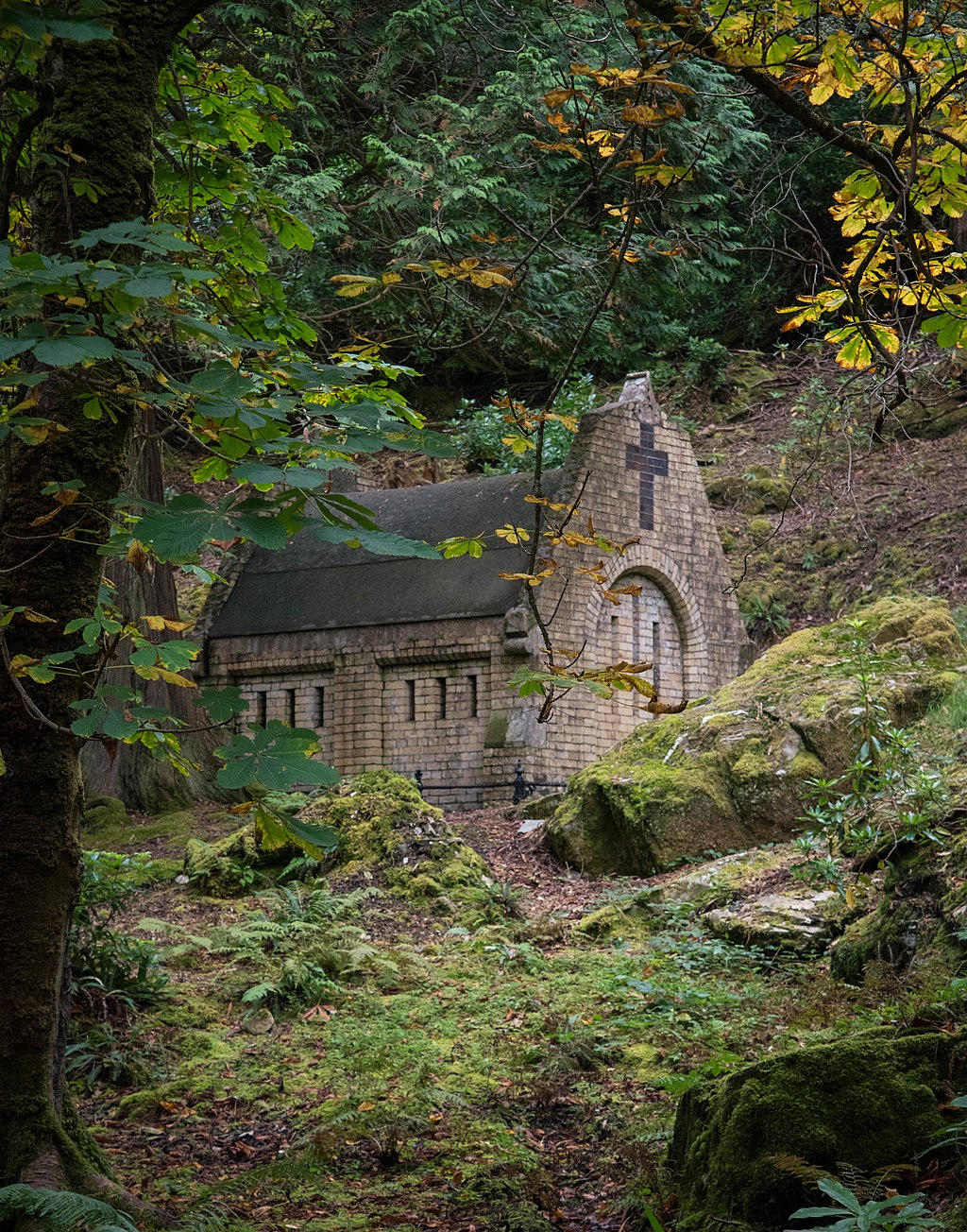 A photograph of Henry Mausoleum in Galway, a small stone building in an autumnal forest