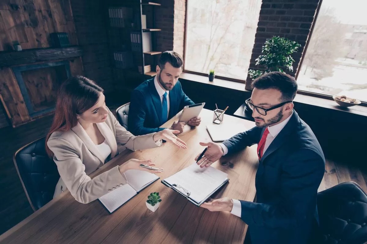 Entrepreneurs discussing a contract at a meeting