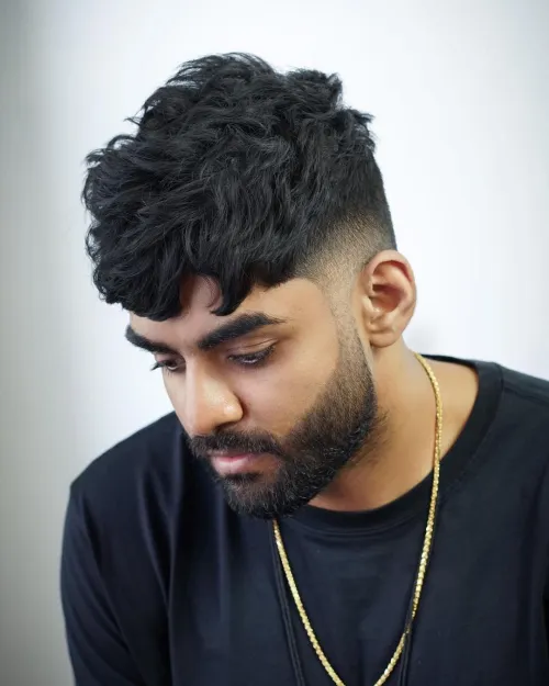 Full picture of a guy rocking the french crop with a curly top