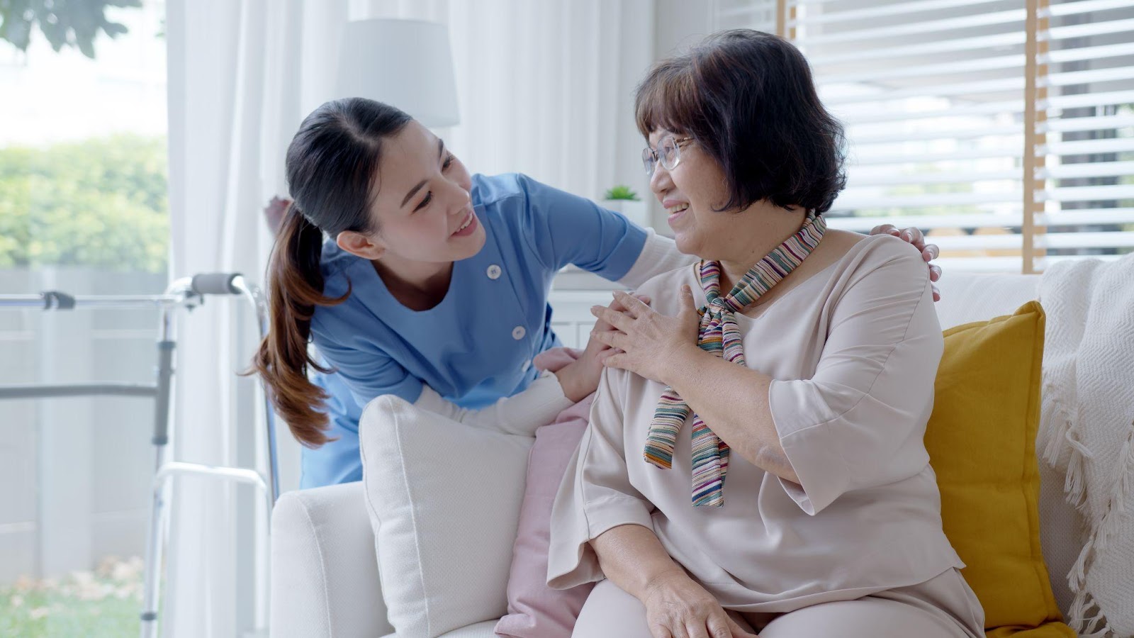 Caregiver caring for a senior woman in an assisted living community