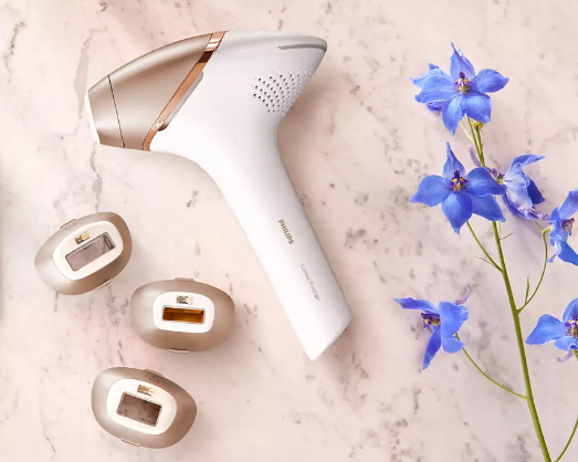 A hair removal device next to a flower

Description automatically generated