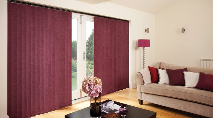 Maroon vertical blinds covering a large bi-fold door