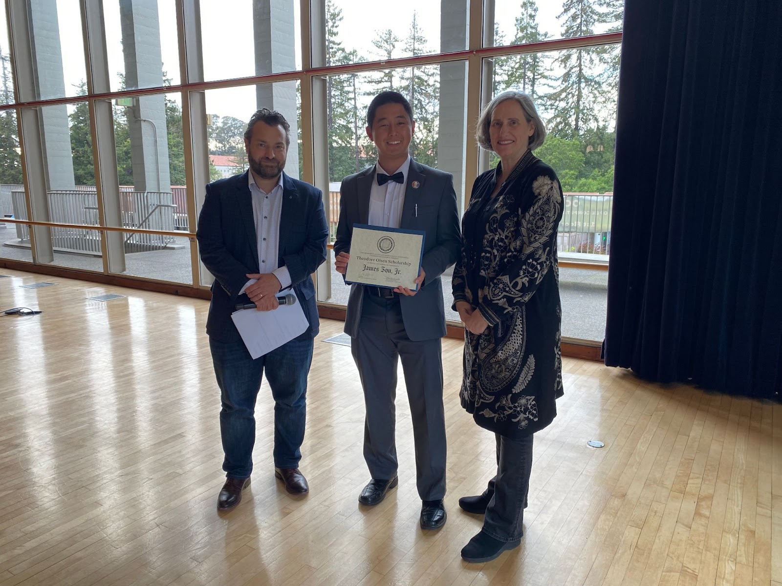 Chair Joan Walker (far right) and CEE Professor Dimitrios Konstantinidis (far left) present James Zou with The Theodore Olsen Scholarship. (Photo Credit: Erin Leigh Inama).