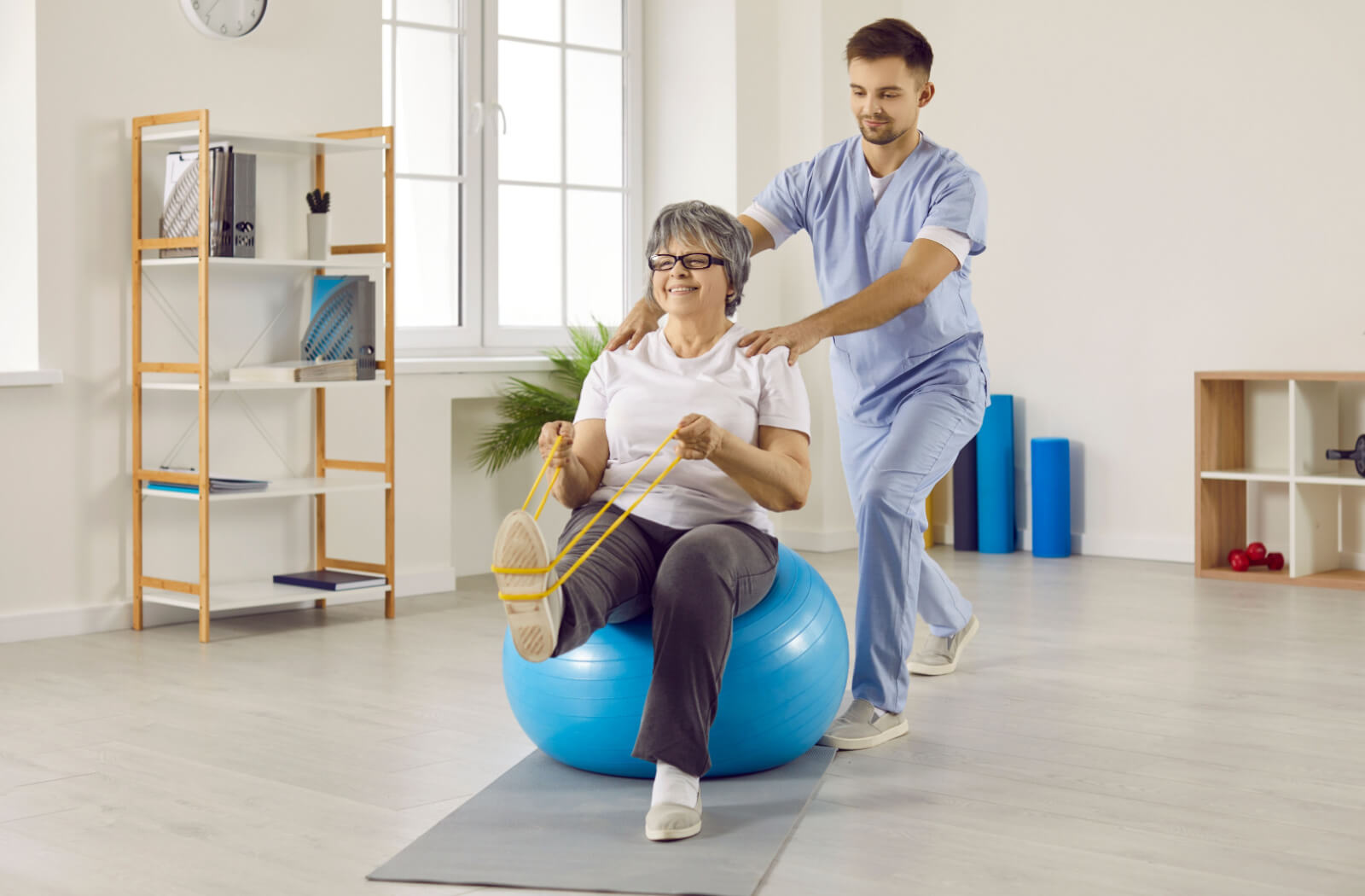 Retirement community resident doing exercises on a yoga ball. 