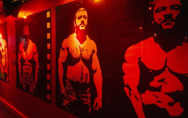 gay muscle daddy artwork in black and white on the walls of local gay bathhouse in fort lauderdale