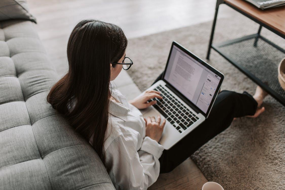 Free Woman Working At Home Using Her Laptop Stock Photo