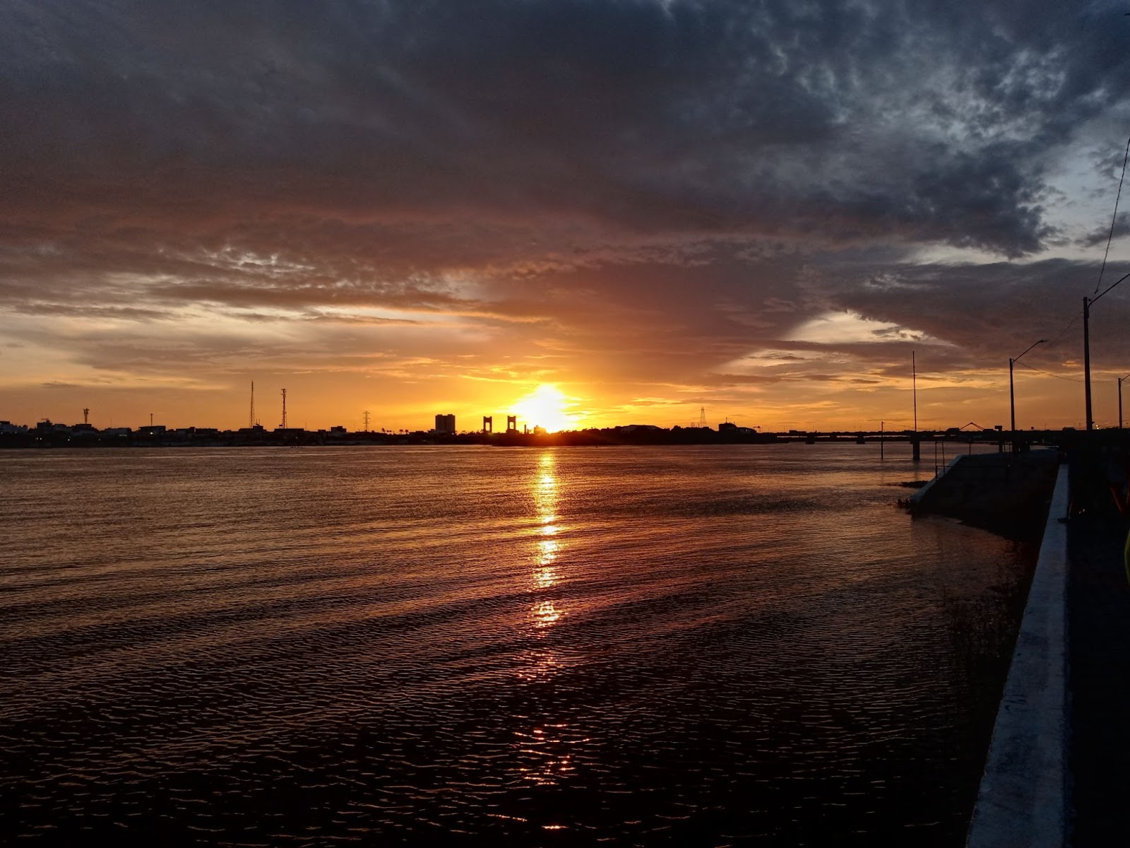 Pôr do sol sobre o Rio São Francisco, em Petrolina. O céu está tingido de dourado por causa da chegada da noite