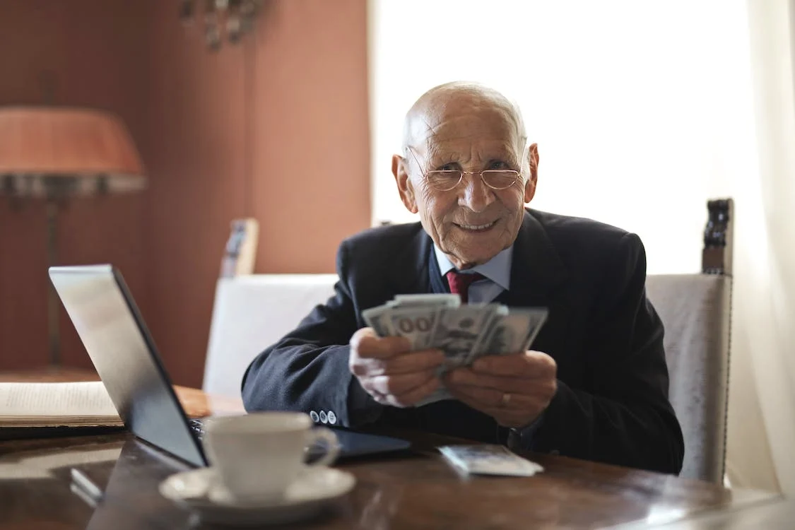 A senior holding up money