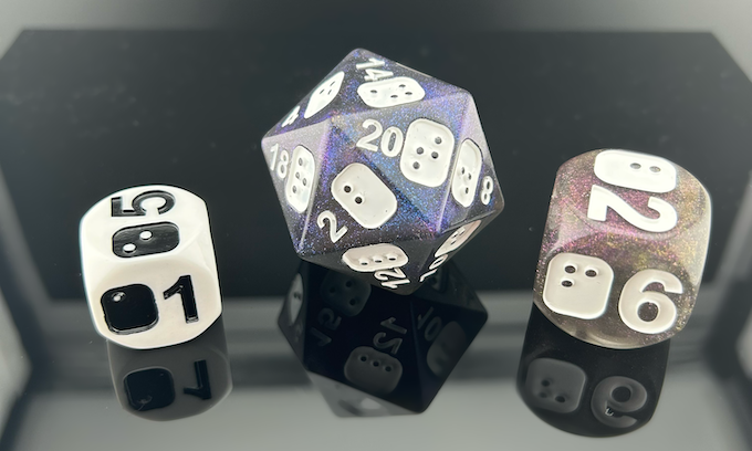3 Dice models from the Inclusive Dice Series: a single D6 from the white and black D6 Level Up, a single D20 from the Galaxy Dice Set, and a single D6 from the D6 Titans. 