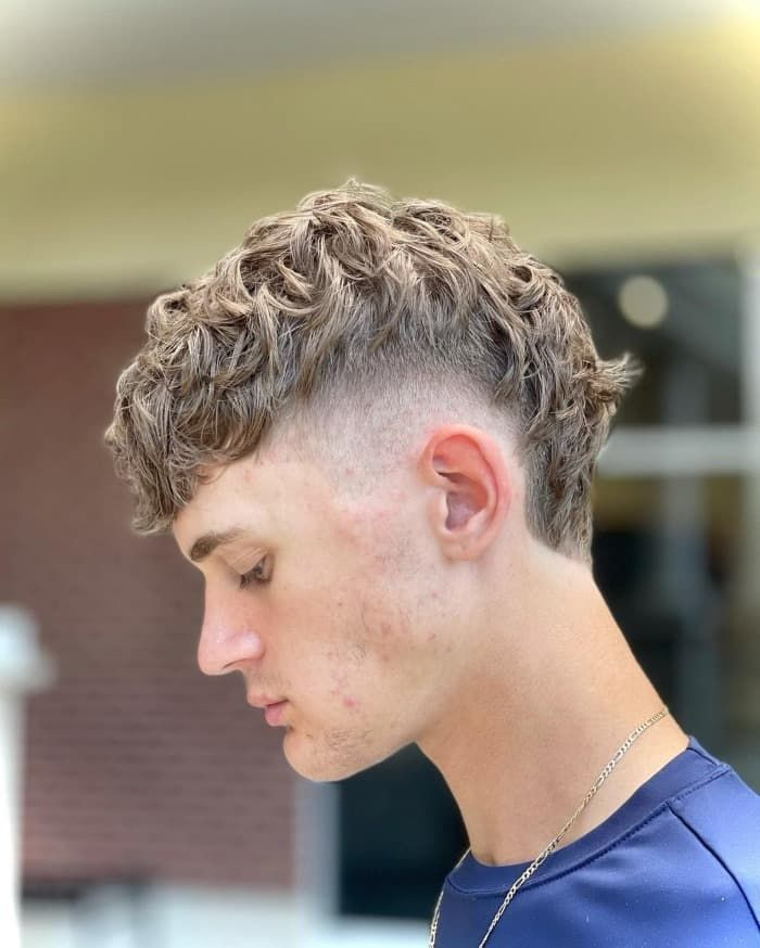 Side view of a man rocking the mullet