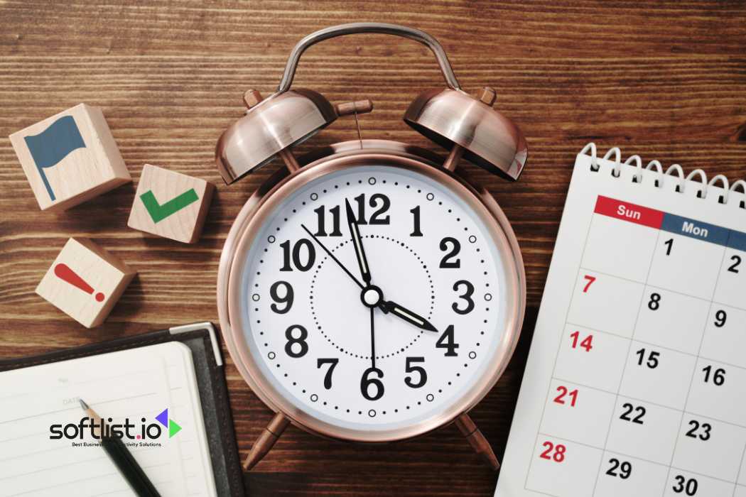 Vintage alarm clock and calendar on wooden table