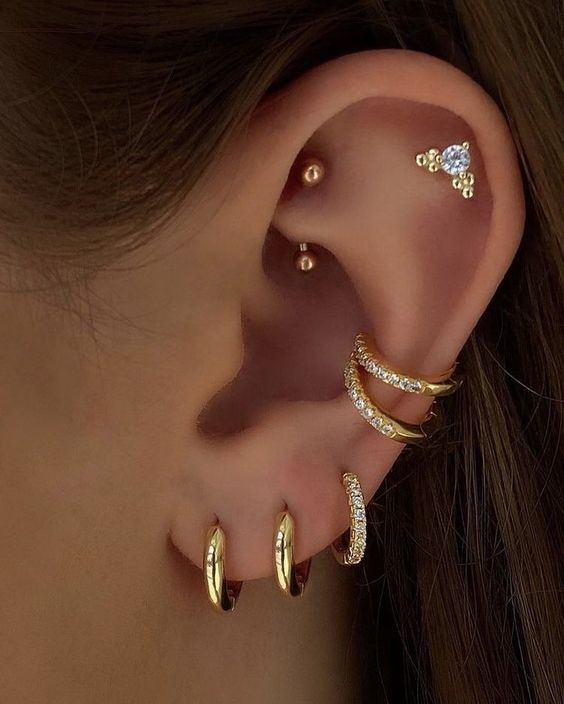 Full picture of a lady rocking multiple earrings