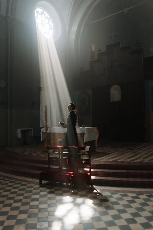 Sunrays Are Passing Through Church and a Man is Praying