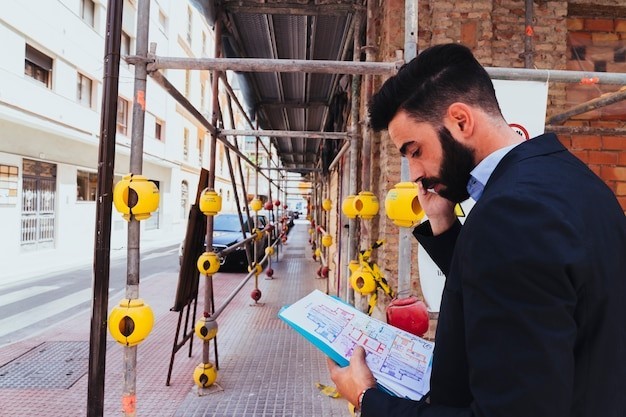 Young businessman working and talking on the phone