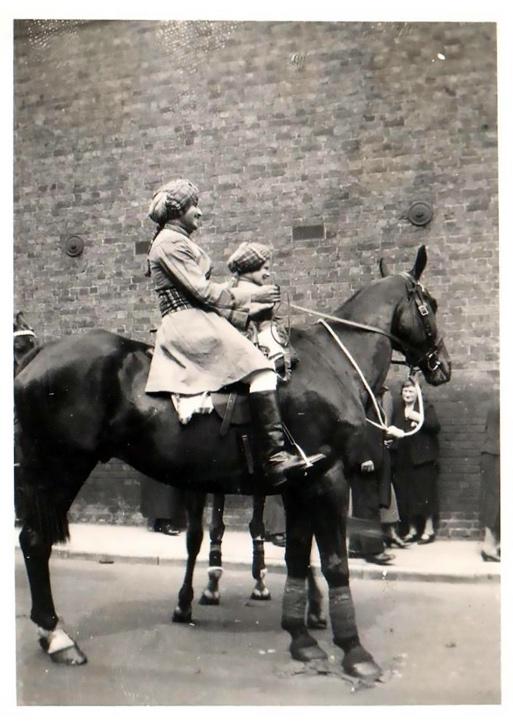 A person holding a child on a horse

Description automatically generated with medium confidence