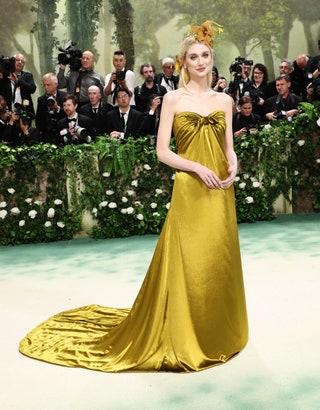 Image may contain Elizabeth Debicki Person Clothing Dress Adult Fashion Camera Electronics Formal Wear and Wedding
