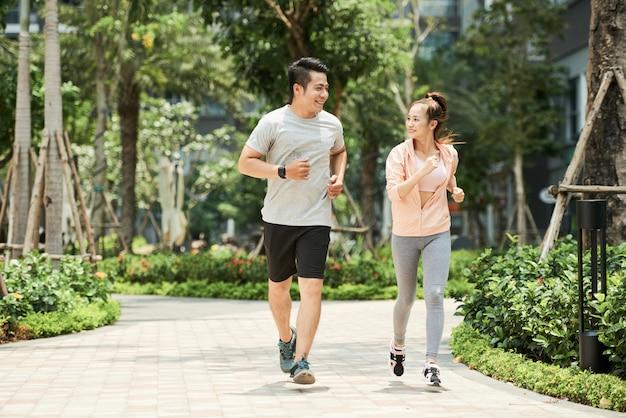 Free photo couple jogging in park