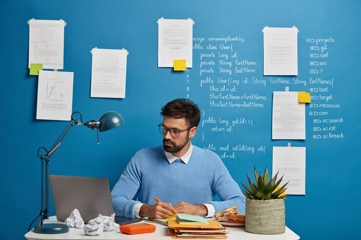 Young millennial student searching information for homework and writing good headlines