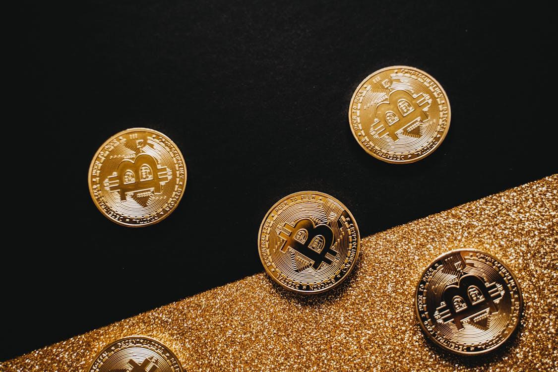 Free Gold Bitcoins on Black Surface Stock Photo