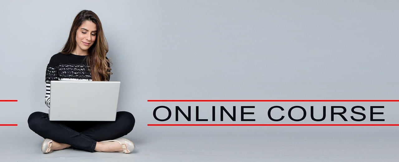 Girl sitting with laptop launching her online course