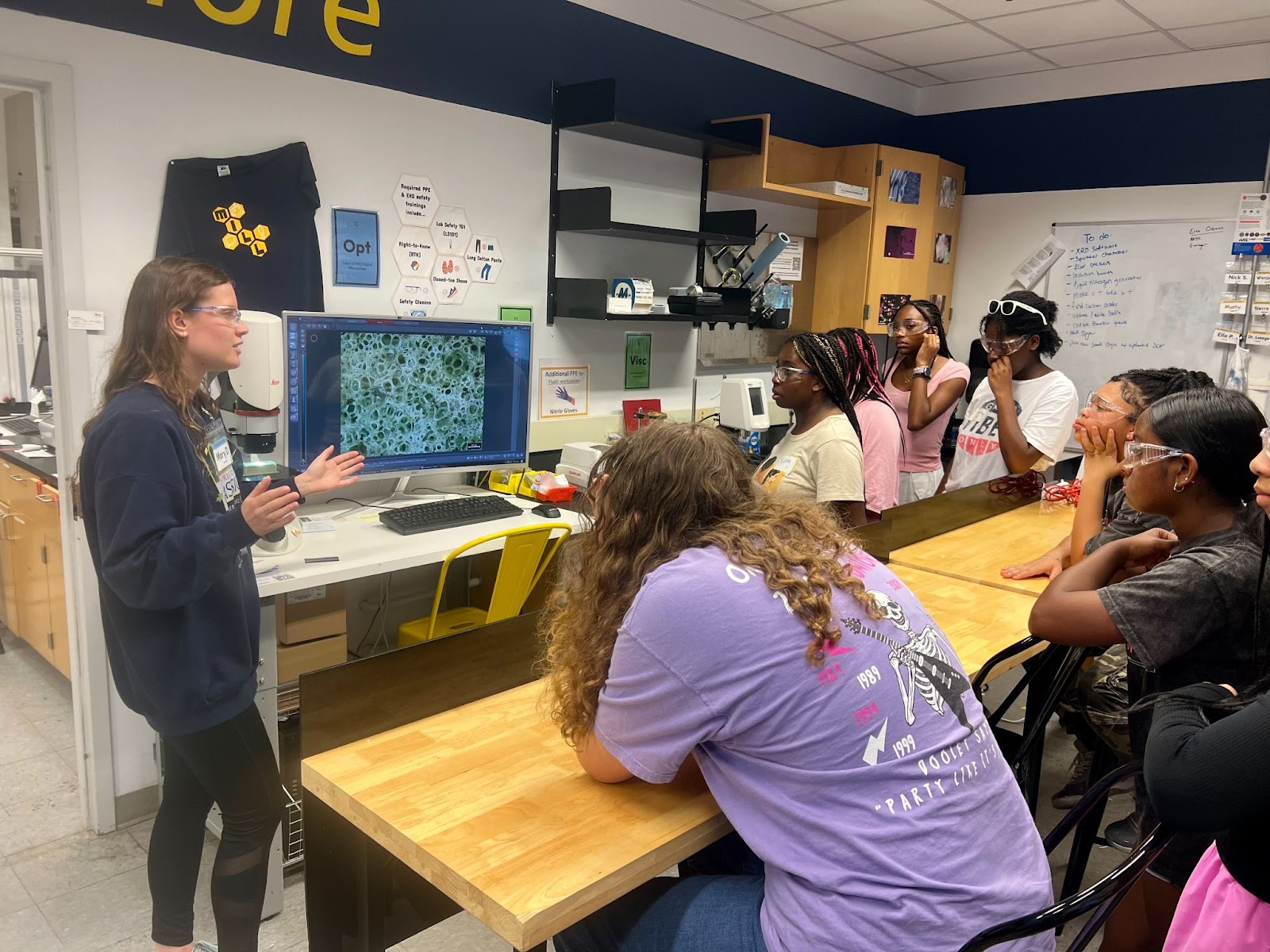 Mary demonstrating the Leica Optical Microscope and SEM during STEM Gems tour