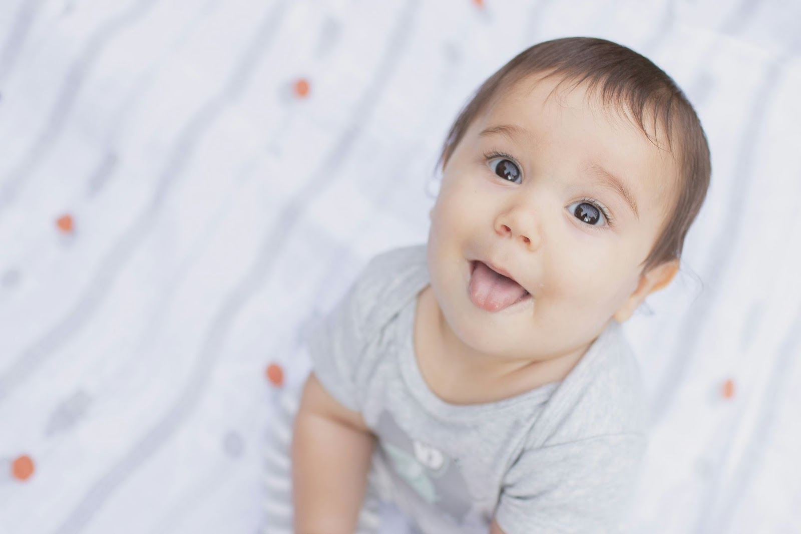 Baby looking up with tongue out