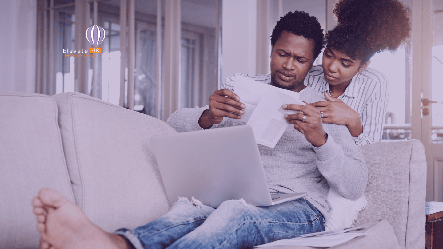 African Couple looking at pay slip