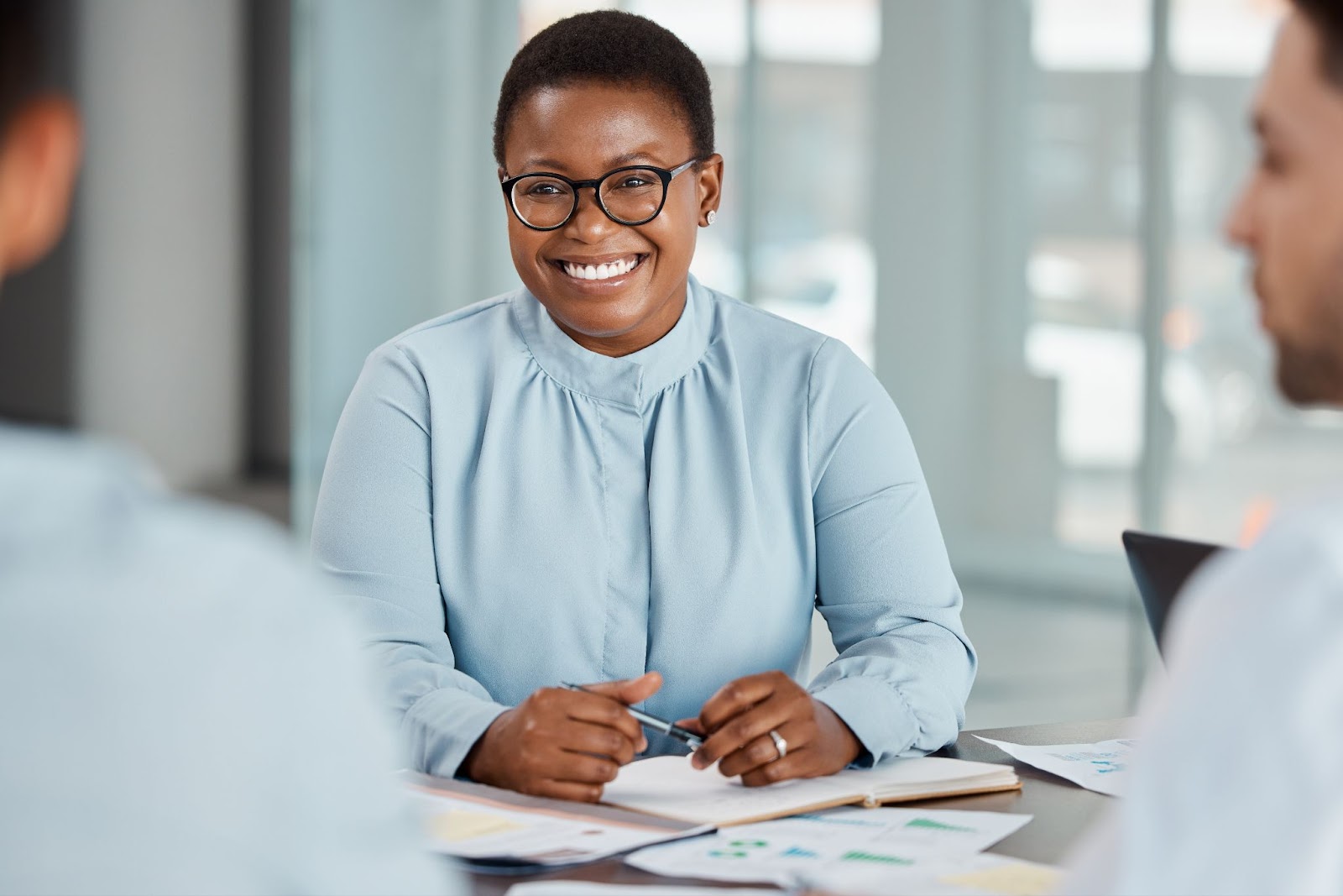 A businesswoman smiles as she is satisfied with the marketing proposal.