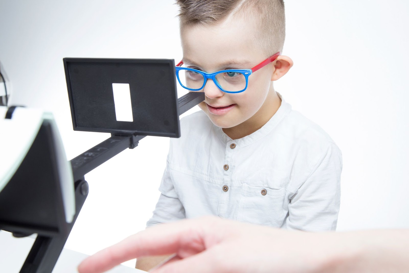 An image of a smiling child wearing glasses in vision therapy.
