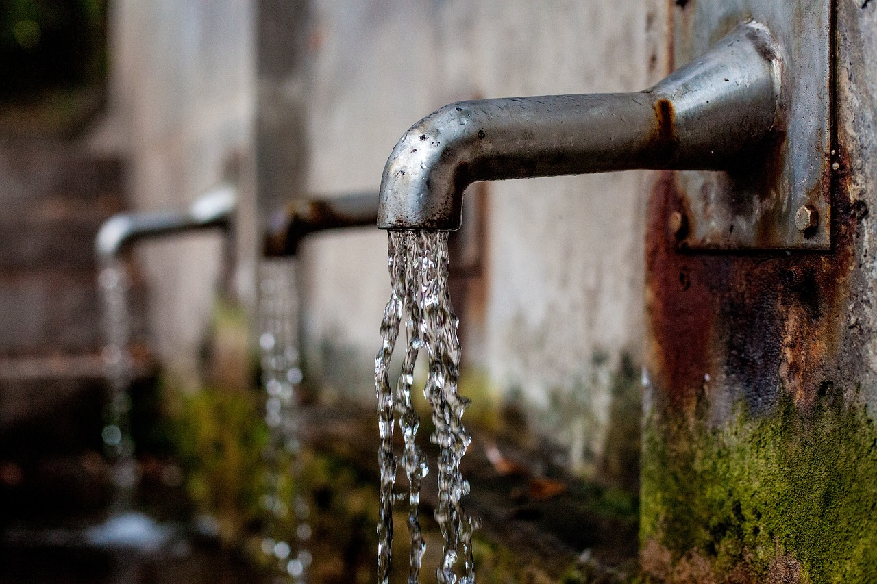 water flowing from rusty old taps