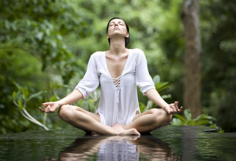 types of pranayama: woman performing one of the pranyama techniques