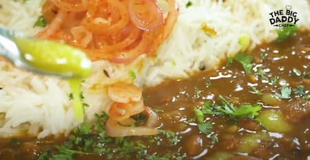 The finished rajma dish garnished with fresh coriander leaves, ready to be served with steamed rice.