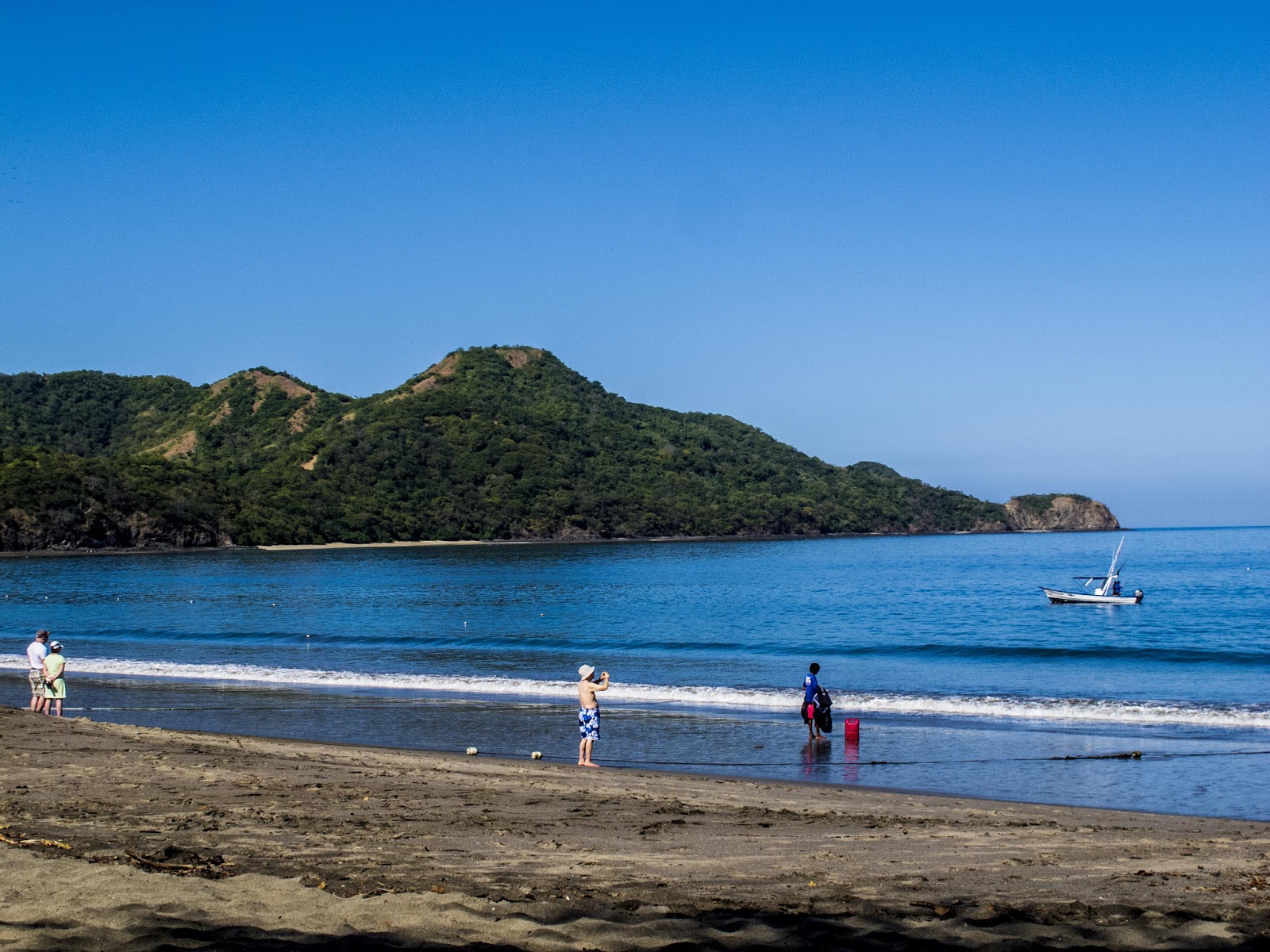 people capturing clear blue lagoons and lush mountains 