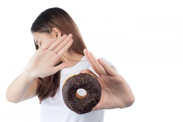 Free photo beautiful asian woman with a happy smile, holding donut in hand