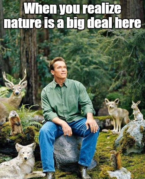 Arnold Schwarzenegger sitting with wild animals