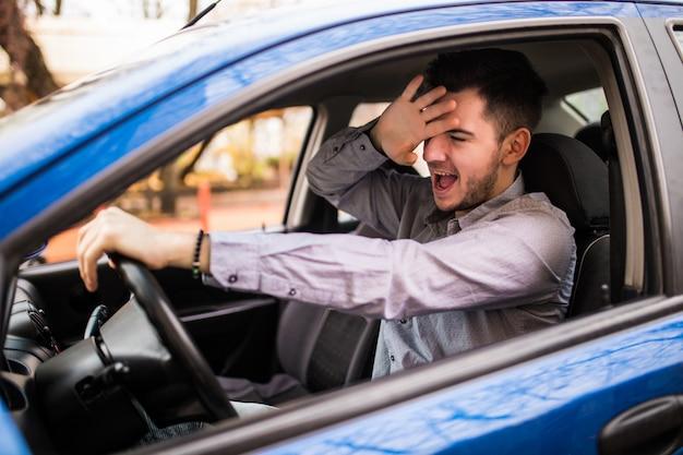 Frustrated man driving car