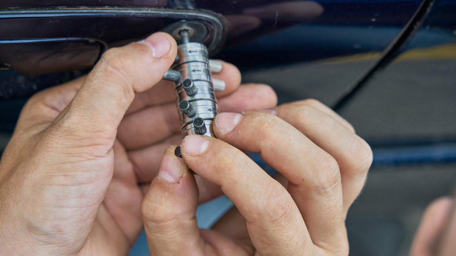 A locksmith uses a specialized tool to provide car door unlock services.