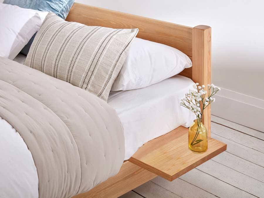 A bed with a side table

Description automatically generated