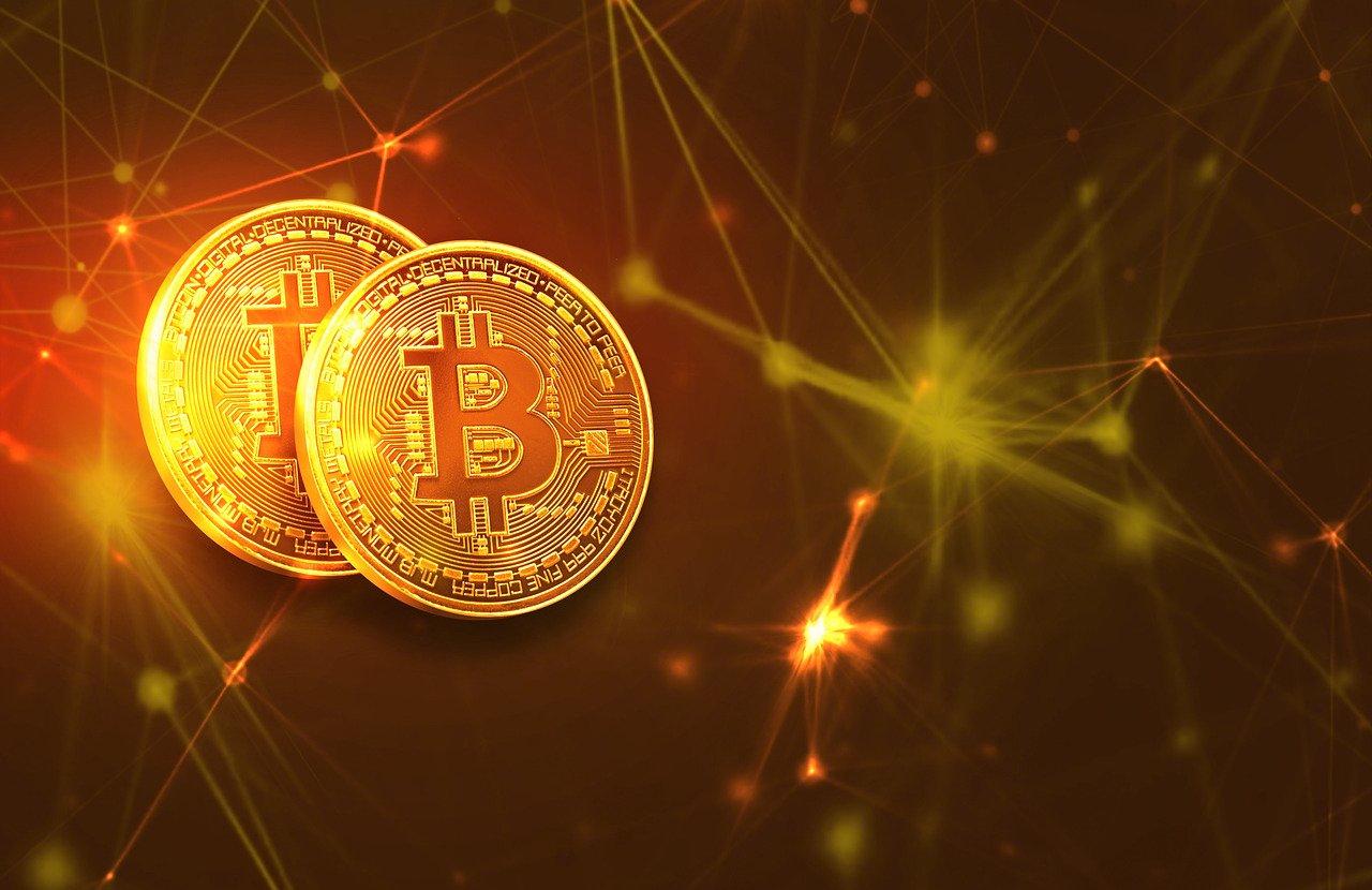 Two golden Bitcoin coins with a network background.