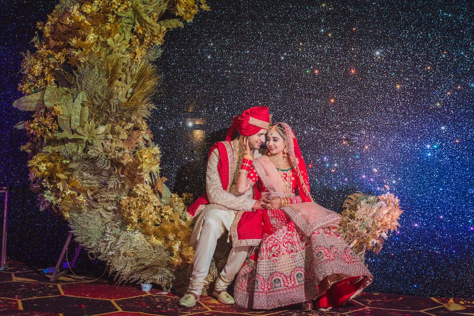 Couple wedding reception portrait - In this captivating image, the couple is looking into each other's eyes with love and joy during their wedding reception. Captured by a professional wedding photographer in Indore, this portrait showcases the emotional connection between the newlyweds. As one of the best wedding photographers in Indore, the photographer has beautifully highlighted the essence of the moment. Known for their creative and traditional wedding photography, this top wedding photographer in Indore offers affordable wedding photography services, making this portrait a perfect addition to their portfolio.