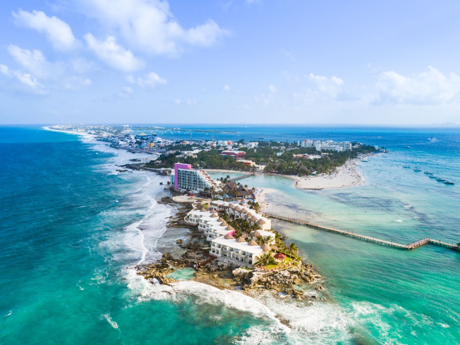 Top view of Isla Mujeres in Cancun showing houses nestled along the coastlines surrounded by beautiful blue water.