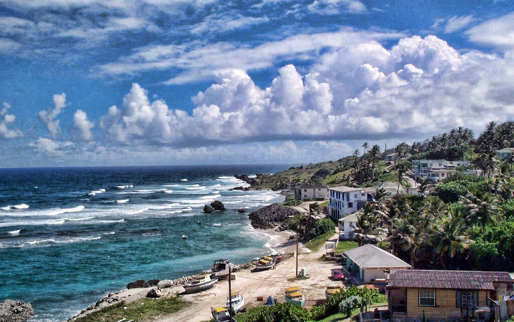 houses and cars in Barbados beachside village.