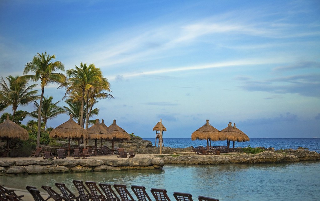 wooden chairs alongside the shore for relaxation.