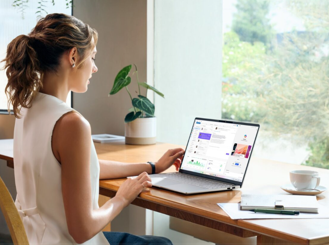 A person sitting at a desk using a computerDescription automatically generated